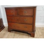 A walnut chest of two short over two long drawers raised on bracket feet 86.5 x 93 x 44cm