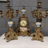 A 19th century continental gilt and porcelain clock garniture, 44cm high