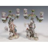 A pair of German porcelain two-branch figural candlesticks, 22.5cm