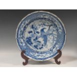 A large Chinese blue and white plate with a peacock and lotus flower, with rubber seal stamped to