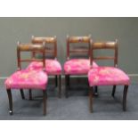 A set of four Regency mahogany dining chairs, upholstered in bright pink and gold rasied on out