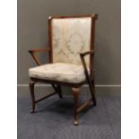 A mahogany frame highback easy armchair on cabriole legs and stretchers, early 20th century,