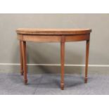 An early 19th century walnut card table on square tapering legs with green felt inset, 73 x 106 x