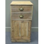 A 20th century pine cabinet comprising of two drawers with brass cup handles over a single