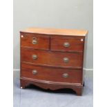 A 19th century bow fronted chest of drawers, fitted with two short and two long drawers, on