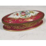 A Paris porcleain and gilt metal mounted oval box with hinged cover, painted with flowers on a