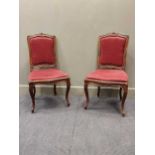 A pair of Hepplewhite style mahogany elbow chairs together with a pair of Louis XV style dining