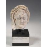 A plaster model of Christ's head on a black painted wooden base, a copy from a late Byzantine lime