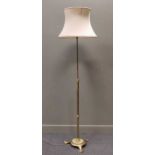 A brass adjustable standard lamp on tripod base, 116cm