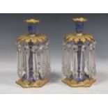 A pair of Ridgeway porcleain candle lustres, the floral sconces supporting cut glass drops, 26cm