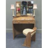 A limed oak barrell back dressing table, the triple mirror over a single drawer together with a