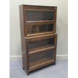 A 1930s oak stacking glazed sectional bookcase, 155 x 87 x 31cm; and another similar smaller