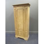 A pine single wardrobe raised on bracket feet, 188 x 86 x 44cm