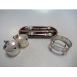 A pair of silver mustard pots, 1934, a Christening trio in damaged case, and a George III oval