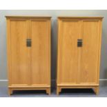 A pair of modern Chinese elm cabinets, each with two cupboard doors enclosing shelves and drawers,