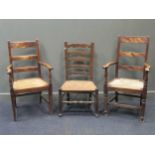 A 19th century rush seated ladder back chair together with two similar ladder back armchairs (3)