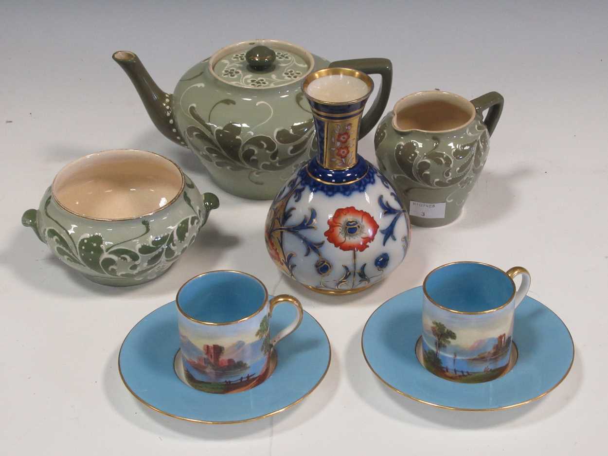 A Macintyre (Moorcroft) vase, a Macintyre three-piece tea set and a pair of coffee cans and