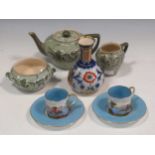 A Macintyre (Moorcroft) vase, a Macintyre three-piece tea set and a pair of coffee cans and