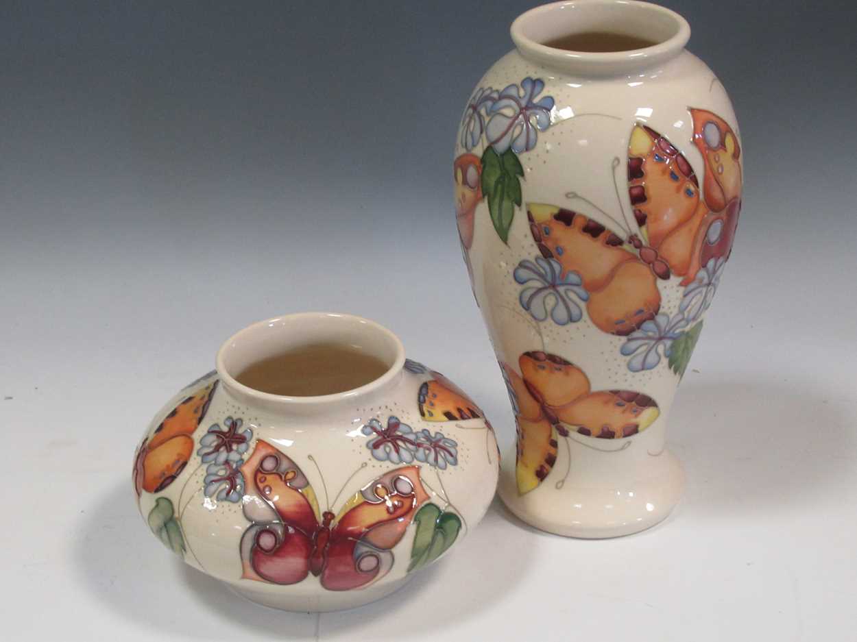 Two modern Moorcroft Butterfly pattern vases, tallest 26cm (2)