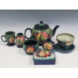 A Moorcroft Leaves & Berries pattern three-piece tea set together with two miniature Moorcroft