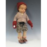 An early 20th century Lenci pressed felt doll of a boy: moulded head with painted eyes, nose and