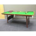 A 20th century snooker table, 83 x 220 x 115cm together with balls and cues (qty)