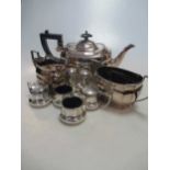 An EPNS three piece teaset and six silver condiments - peppers, salts and mustards with spoons