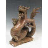 A carved wood model of a dragon, 43cm high, together with a polychrome painted carved wood Thai