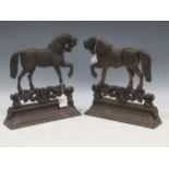 A pair of cast iron door stops modelled as shire horses