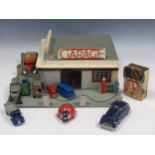 A model toy garage, probably 1950s, with various Dinky, Minic and other model trucks and cars