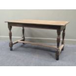 An 18th century oak refectory table, the four plank cleated top raised on turned legs united by