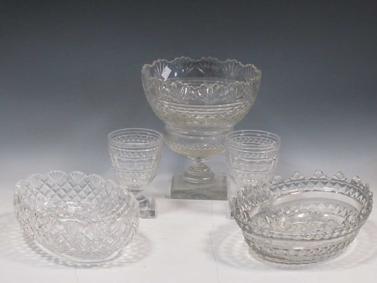 A pair of Georgian style cut glass vessels on a square foot, a 19th century cut glass stem bowl, a