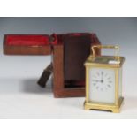 A French brass carriage timepiece, with a leather travel case, 12 x 8 x 6.5cm