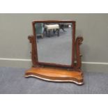 A Victorian mahogany swing mirror, the rectangular plate with moulded frame flanked by acanthus