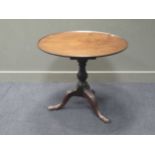 A George III mahogany tilt top tripod table, with carved legs, 72 x 78cm diam.