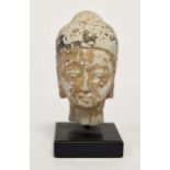 A Thai gilded and lacquered small stone head of Buddha, perhaps 18th/19th century,