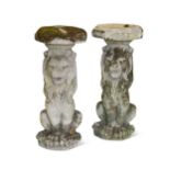 A pair of composite stone seated garden lions, 20th century,