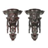 A pair of 17th century style carved and stained wall brackets, 20th century,