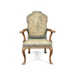 A walnut elbow chair, in the 18th century manner,