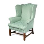 A George III mahogany wing back armchair,