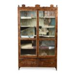 A stained pine two-door glazed cabinet, early 20th century,