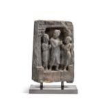A Gandharan grey schist Buddha and two disciples temple panel, 2nd/3rd century,