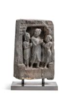 A Gandharan grey schist Buddha and two disciples temple panel, 2nd/3rd century,