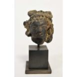 A Greco-Gandharan small black painted terracotta head of a Maiden, 3rd-5th century,