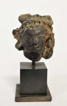 A Greco-Gandharan small black painted terracotta head of a Maiden, 3rd-5th century,