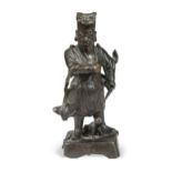 A Chinese bronze small figure of an Official, late Ming Dynasty,