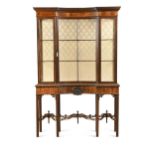 A mahogany display cabinet with concave central door, early 20th century,