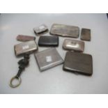 A collection of silver cigarette cases, together with a matchbox sleeve, card case, rattle etc,