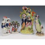 A large collection of Staffordshire flatbacks and other ceramic figurines, tallest 32cm