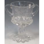 A 1911 George V and Queen Mary Coronation commemorative glass two handled vase with inset coin, 21cm